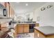 Open kitchen area with wood cabinets, a view to the living area, and modern appliances at 927 Orange Cosmos Blvd, Davenport, FL 33837