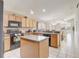 Efficient kitchen featuring wood cabinets, stainless appliances, and a breakfast bar at 927 Orange Cosmos Blvd, Davenport, FL 33837
