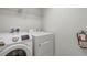 A practical laundry room with modern white washer and dryer units at 927 Orange Cosmos Blvd, Davenport, FL 33837