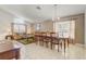 Inviting living room and dining area with tile floors, a chandelier, and large windows at 927 Orange Cosmos Blvd, Davenport, FL 33837
