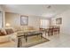 Inviting living room with comfortable seating, tile floors, and a view into the dining room at 927 Orange Cosmos Blvd, Davenport, FL 33837