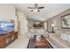 Spacious living room with neutral-toned furnishings, tile flooring, and seamless kitchen access at 927 Orange Cosmos Blvd, Davenport, FL 33837