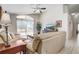 Bright living room with vaulted ceilings, sliding door access to outdoor pool area, and tile floors at 927 Orange Cosmos Blvd, Davenport, FL 33837