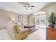 Inviting living room with plush seating, ceiling fan, and sliding door access to the screened-in lanai at 927 Orange Cosmos Blvd, Davenport, FL 33837