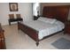 Well-lit main bedroom featuring a large bed, neutral decor, and tiled floors at 927 Orange Cosmos Blvd, Davenport, FL 33837