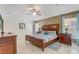 Well-appointed main bedroom with tiled floors, side tables, and a ceiling fan at 927 Orange Cosmos Blvd, Davenport, FL 33837