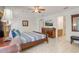 Comfortable main bedroom with ceiling fan, TV, and access to the bathroom at 927 Orange Cosmos Blvd, Davenport, FL 33837