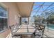 A screened-in patio has dining furniture and overlooks a swimming pool and the outdoors at 927 Orange Cosmos Blvd, Davenport, FL 33837
