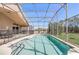 Screened-in pool and lanai with outdoor kitchen and lush backyard view at 927 Orange Cosmos Blvd, Davenport, FL 33837