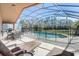 Screened pool with outdoor furniture on the patio, offering a serene backyard retreat at 927 Orange Cosmos Blvd, Davenport, FL 33837