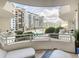 This condo balcony features comfortable seating with views of the community pool and surrounding buildings at 100 S Eola Dr # 611, Orlando, FL 32801