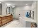 Bright bathroom with a modern tub, a glass-enclosed shower, and sleek wooden vanity at 100 S Eola Dr # 611, Orlando, FL 32801