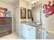 Bathroom with white cabinets, granite countertop, decorative elements, and a mirror reflecting the room at 100 S Eola Dr # 611, Orlando, FL 32801