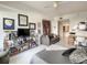 Bright bedroom featuring eclectic decor, tile floors, a gray sofa bed, and access to an ensuite bathroom and work area at 100 S Eola Dr # 611, Orlando, FL 32801