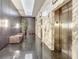 Condominium hallway featuring marble walls, elevator access, and elegant lighting at 100 S Eola Dr # 611, Orlando, FL 32801