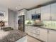 Well-lit kitchen featuring granite counters, stainless appliances, white cabinets, and tile backsplash at 100 S Eola Dr # 611, Orlando, FL 32801