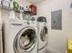 This is a laundry room featuring a side-by-side washer and dryer at 100 S Eola Dr # 611, Orlando, FL 32801
