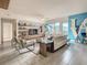 Open living room with contemporary furnishings, expansive windows offering city views, and a unique mural at 100 S Eola Dr # 611, Orlando, FL 32801