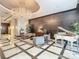 Opulent lobby with marble floors, chandelier, seating, and a grand piano creating a luxurious ambiance at 100 S Eola Dr # 611, Orlando, FL 32801