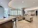 Inviting lounge area with comfortable seating, tiled floor, and stylish bar area in a modern community clubhouse at 100 S Eola Dr # 611, Orlando, FL 32801