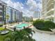 Community swimming pool featuring plenty of seating, lush landscaping, and city views in the background at 100 S Eola Dr # 611, Orlando, FL 32801