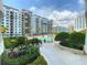 Beautiful community pool area with lush landscaping and modern condominium buildings in the background at 100 S Eola Dr # 611, Orlando, FL 32801