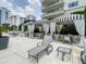 Community pool with covered seating and lounge area, surrounded by lush greenery and upscale condos at 100 S Eola Dr # 611, Orlando, FL 32801