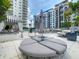 Poolside area featuring a unique seating arrangement with lounge chairs and an umbrella for relaxation at 100 S Eola Dr # 611, Orlando, FL 32801