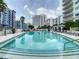 Community pool surrounded by luxury condos and palm trees offering a serene and upscale ambiance at 100 S Eola Dr # 611, Orlando, FL 32801
