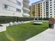 A grassy turf area with comfortable seating and lush landscaping, creating a relaxing outdoor space at 100 S Eola Dr # 611, Orlando, FL 32801