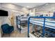 Fun bedroom featuring bunkbeds, Star Wars decor, space-themed wallpaper, and a plush armchair at 10251 Ebb Tide Ln, Orlando, FL 32821