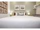 Cozy bedroom with neutral decor, a wood frame bed, side tables with lamps, and decorative wall art at 10251 Ebb Tide Ln, Orlando, FL 32821