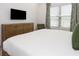 Bright bedroom offering a calming atmosphere, complete with a modern TV for entertainment and a cozy sitting area at 10251 Ebb Tide Ln, Orlando, FL 32821
