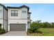 Beautiful two-story home featuring a gray garage door, manicured lawn, and a contemporary design at 10251 Ebb Tide Ln, Orlando, FL 32821