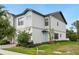 Contemporary two-story home with clean lines, manicured lawn, and a charming light blue front door at 10251 Ebb Tide Ln, Orlando, FL 32821