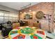 Recreational room featuring brick accent wall, lounge seating, and poker table at 10251 Ebb Tide Ln, Orlando, FL 32821