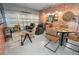Spacious room with decorative brick, a poker table, leather chairs, and a garage door creating a versatile living space at 10251 Ebb Tide Ln, Orlando, FL 32821