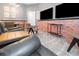 Features brick detail, leather furniture, dual TV setup, creating a lively and sophisticated atmosphere at 10251 Ebb Tide Ln, Orlando, FL 32821