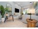Cozy living room featuring neutral tones, a large TV, modern décor, and access to the outdoors at 10251 Ebb Tide Ln, Orlando, FL 32821