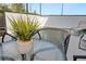 Patio table featuring a decorative green plant with outdoor chairs, with a pool and loungers visible at 10251 Ebb Tide Ln, Orlando, FL 32821