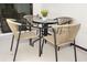 Close up of patio table and chairs with black metal frame and light wicker seating at 10251 Ebb Tide Ln, Orlando, FL 32821
