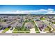 Community aerial view showcasing homes with solar panels in a well-planned neighborhood with tree-lined streets and green spaces at 1120 Saguaro St, Haines City, FL 33844