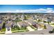 This aerial view showcases a neighborhood with modern single-Gathering homes and well-maintained landscaping under a bright sky at 1120 Saguaro St, Haines City, FL 33844