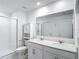 Clean bathroom featuring double vanity, lots of light, walk-in shower with white tiles at 1120 Saguaro St, Haines City, FL 33844