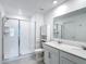 Bright bathroom with double sinks, white cabinets, walk-in shower and modern fixtures at 1120 Saguaro St, Haines City, FL 33844