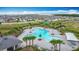 Aerial view of a lavish community pool surrounded by palm trees and lounge chairs at 1120 Saguaro St, Haines City, FL 33844