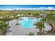 Aerial view of a well-equipped community pool, complemented by lush landscaping and seating at 1120 Saguaro St, Haines City, FL 33844