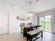 Bright dining room featuring a modern chandelier and sliding glass door with backyard view at 1120 Saguaro St, Haines City, FL 33844