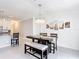 Dining room with a modern chandelier, a dark wood table, and seating with neutral tones at 1120 Saguaro St, Haines City, FL 33844