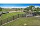 Fenced in community dog park with pet waste station and room for dogs to roam and socialize in a secure setting at 1120 Saguaro St, Haines City, FL 33844
